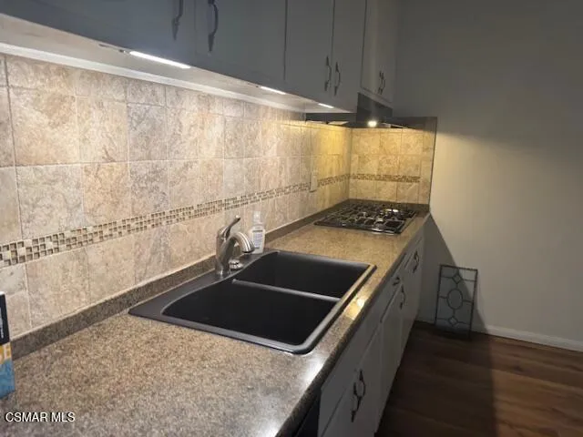 a kitchen with a stove and a sink