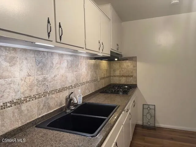 a kitchen with a sink and cabinets