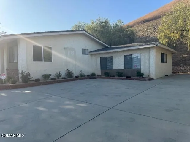 a white house with a tree in front of it