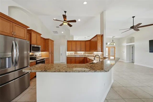 a kitchen with stainless steel appliances granite countertop a sink and dishwasher a stove top oven with wooden floor