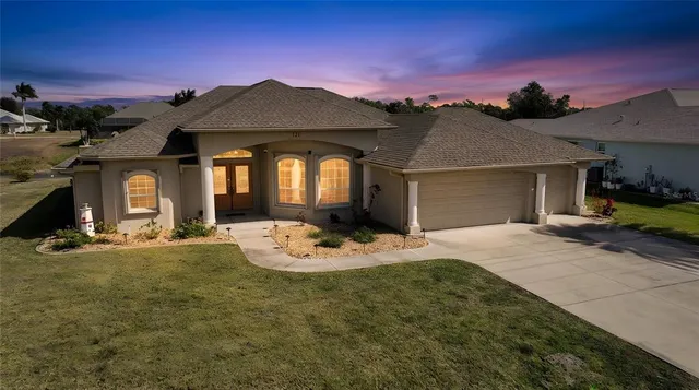 a front view of a house with a yard and garage