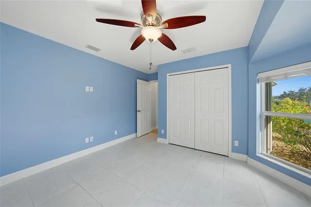 a bathroom with a granite countertop sink a mirror and a toilet