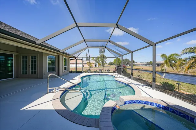 a swimming pool with outdoor seating and yard
