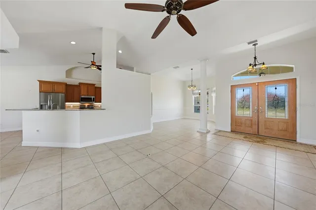 a view of a kitchen with furniture and an empty room