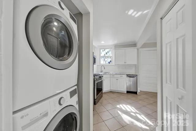 a kitchen with granite countertop a refrigerator stove and sink