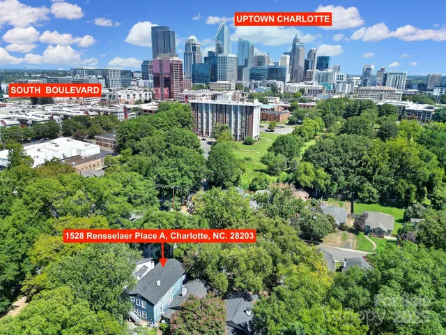 an aerial view of a house with a yard and garden