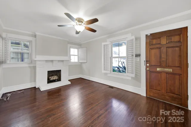 a view of an empty room with wooden floor