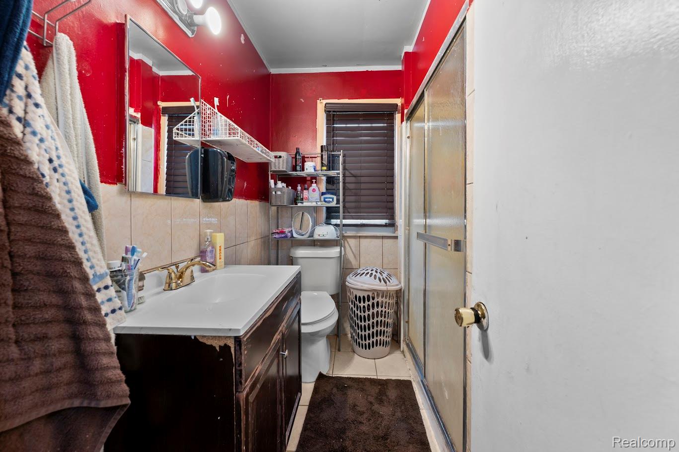 6800 Longacre Street Detroit, MI 48228 - Photo 14 of 24 Bathroom with a stall shower, vanity, and light tile patterned floors