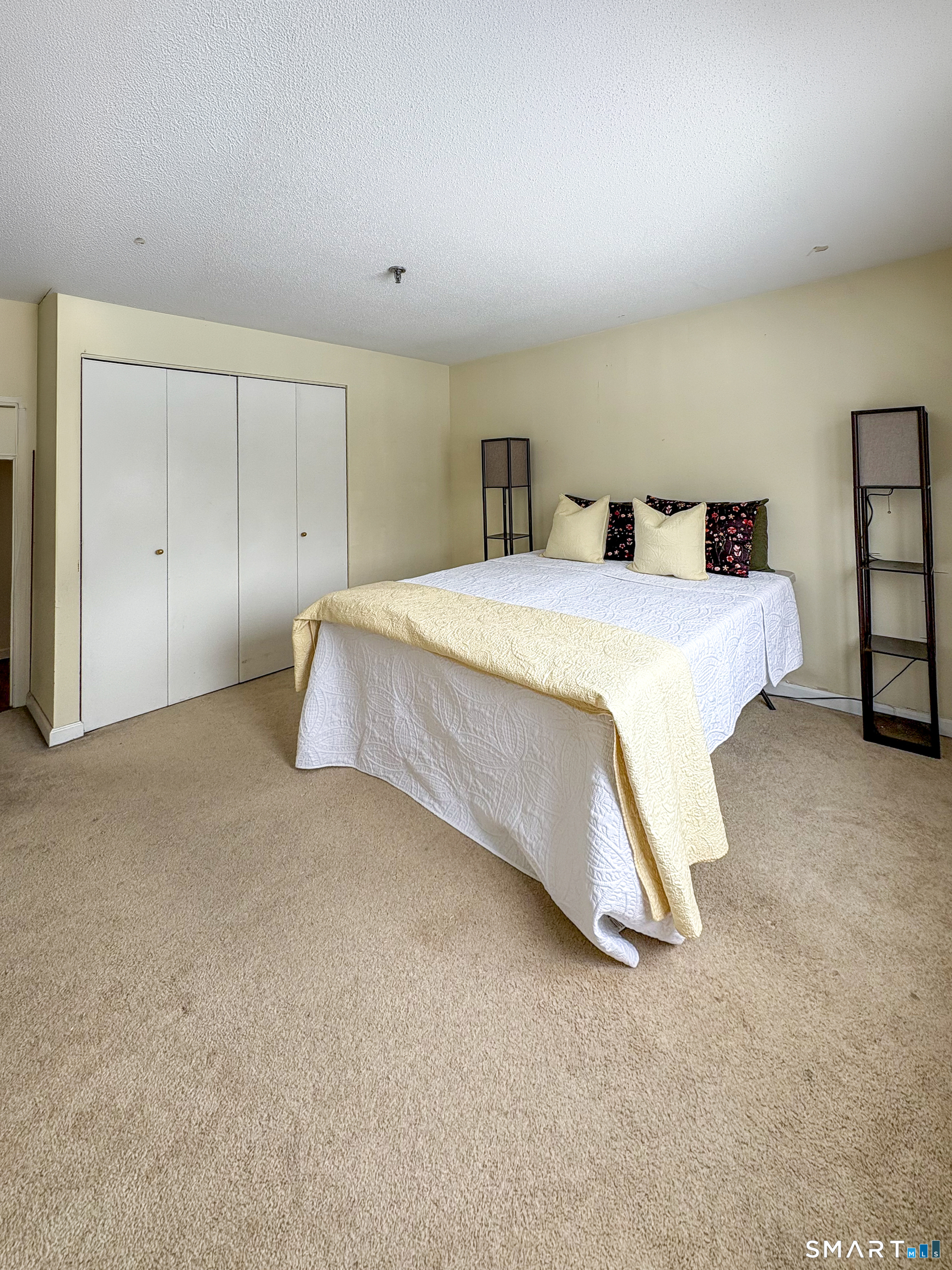 21 Putter Drive, Unit 303S Wallingford, CT 06492 - Photo 1 of 30 a spacious bedroom with a bed and a window