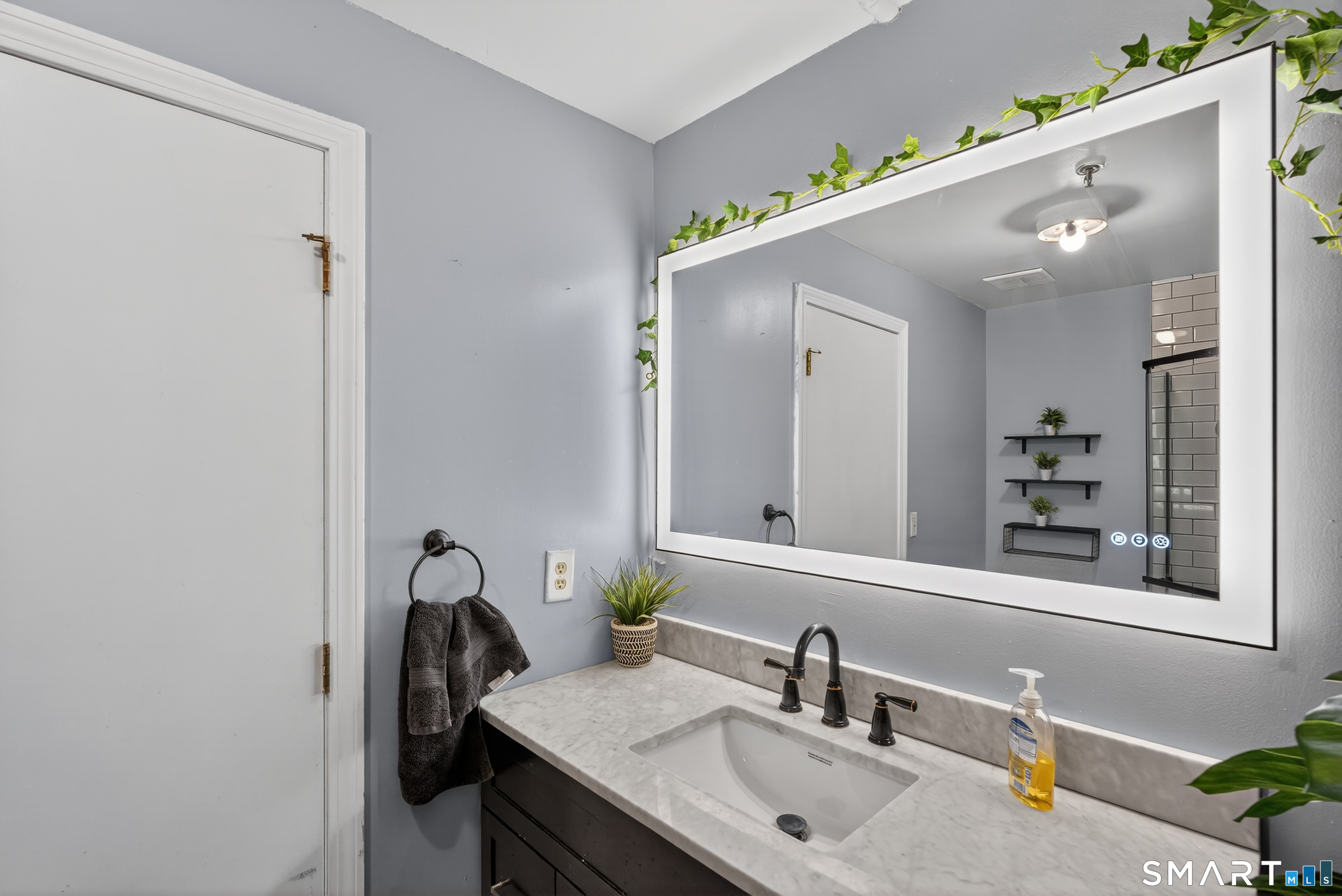 21 Putter Drive, Unit 303S Wallingford, CT 06492 - Photo 14 of 30 a bathroom with a sink and a mirror