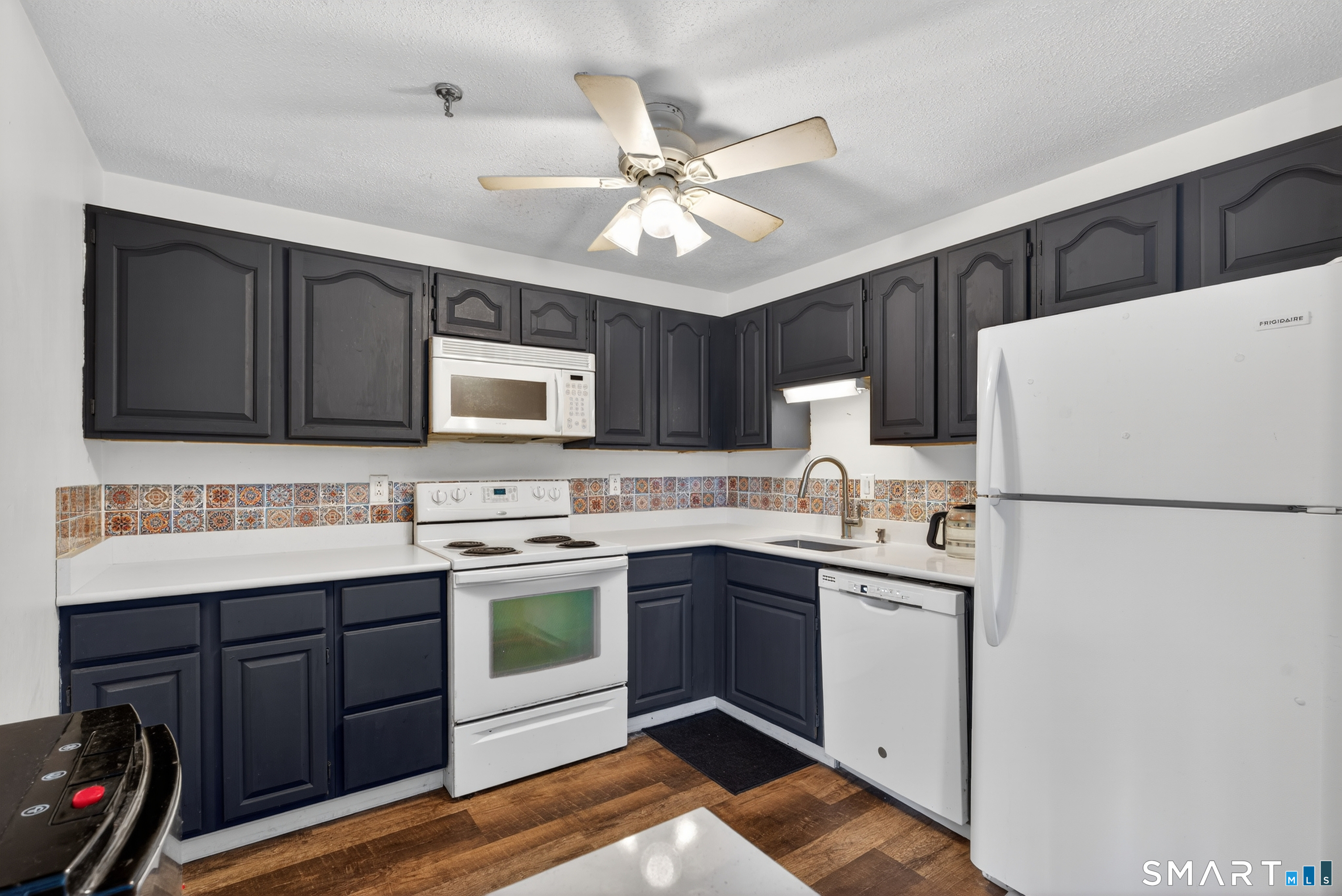 21 Putter Drive, Unit 303S Wallingford, CT 06492 - Photo 23 of 30 a kitchen with a sink a refrigerator and cabinets
