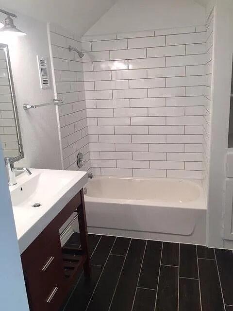 2915 21st Street Lubbock, TX 79410 - Photo 17 of 18 a bathroom with a bathtub and sink