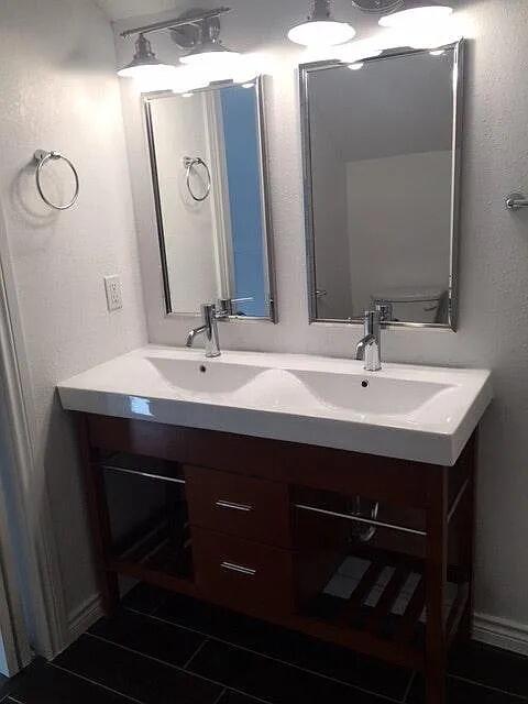 2915 21st Street Lubbock, TX 79410 - Photo 5 of 18 a bathroom with a sink vanity and a mirror
