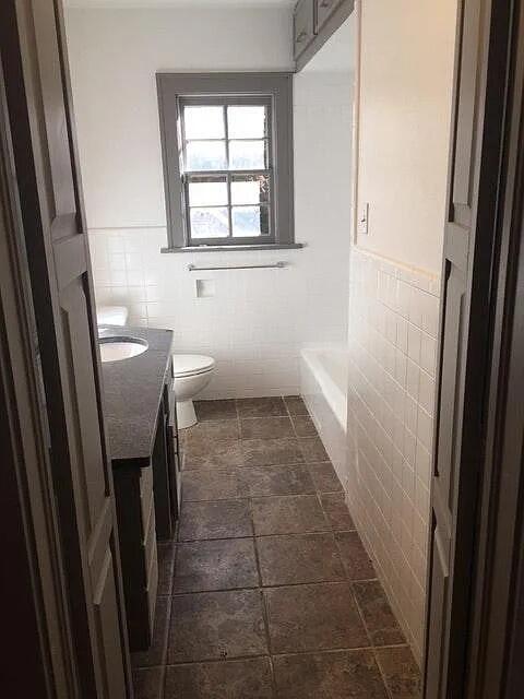 2915 21st Street Lubbock, TX 79410 - Photo 7 of 18 a bathroom with a sink a toilet and a window