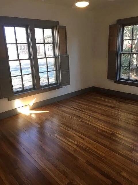 2915 21st Street Lubbock, TX 79410 - Photo 9 of 18 wooden floor in an empty room with a window