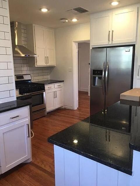 2915 21st Street Lubbock, TX 79410 - Photo 10 of 18 a kitchen with stainless steel appliances granite countertop a sink a stove and a refrigerator