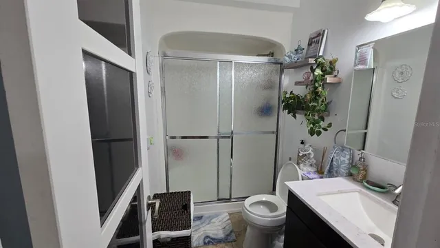 a bathroom with a sink toilet and shower