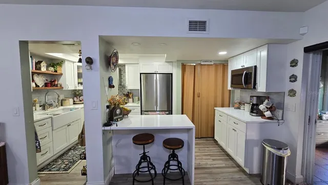 a kitchen with cabinets a sink and appliances