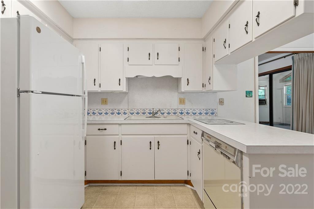 312 Brookside Drive Fort Mill, SC 29715 - Photo 13 of 23 a kitchen with granite countertop white cabinets and refrigerator