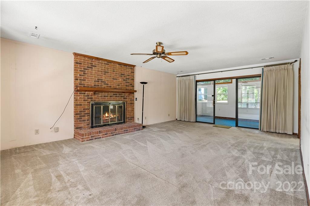 312 Brookside Drive Fort Mill, SC 29715 - Photo 6 of 23 an empty room with windows and fireplace