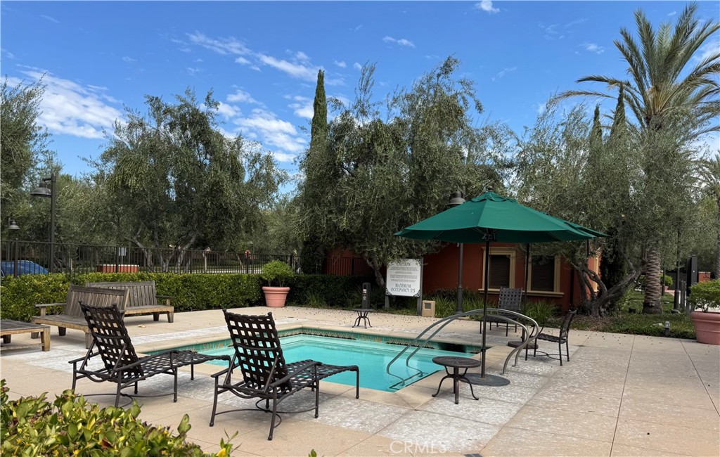 89 Kestrel Irvine, CA 92618 - Photo 33 of 36 a view of backyard with outdoor seating a patio and plants