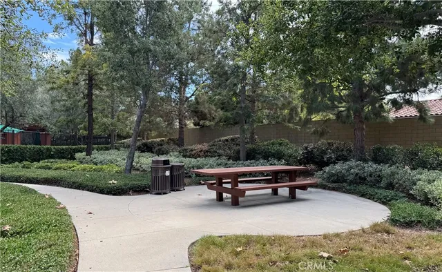 a swimming pool with outdoor seating and green space