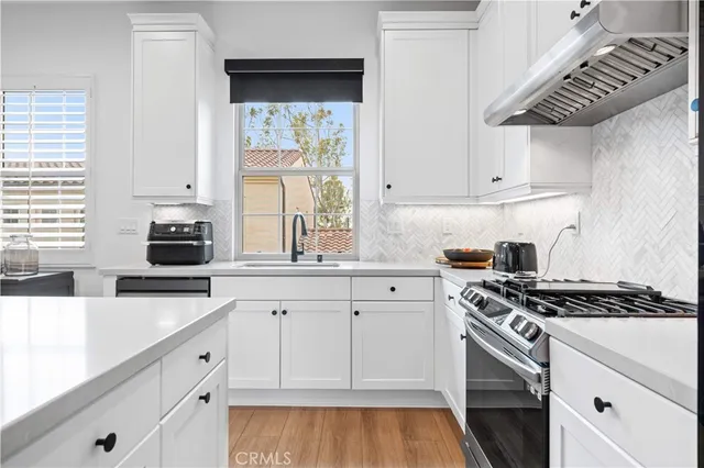 a kitchen with granite countertop a stove and a sink