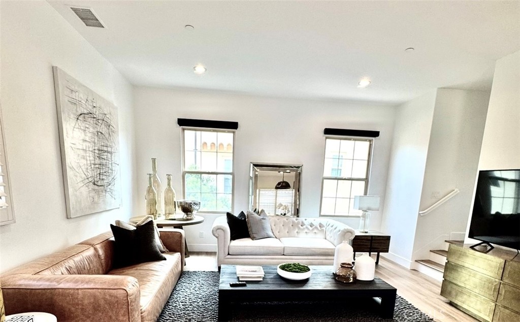 89 Kestrel Irvine, CA 92618 - Photo 9 of 36 a living room with furniture and large windows