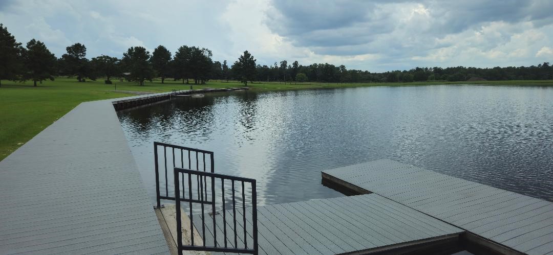 16029 Ridge Oak Road Willis, TX 77378 - Photo 7 of 10 a view of a lake with houses in the back