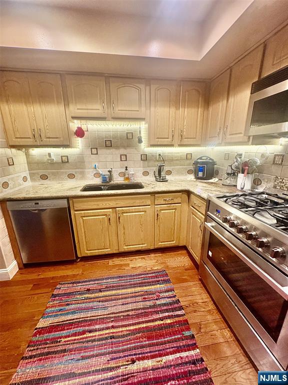 51 Beacon Hill Road, Unit C West Milford, NJ 07480 - Photo 5 of 31 a kitchen with stainless steel appliances granite countertop a sink stove and cabinets