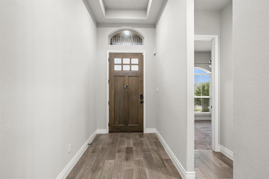 1501 Calcot Lane Forney, TX 75126 - Photo 8 of 34 Entryway featuring a wood-finish front door with glass panels and an arched transom window