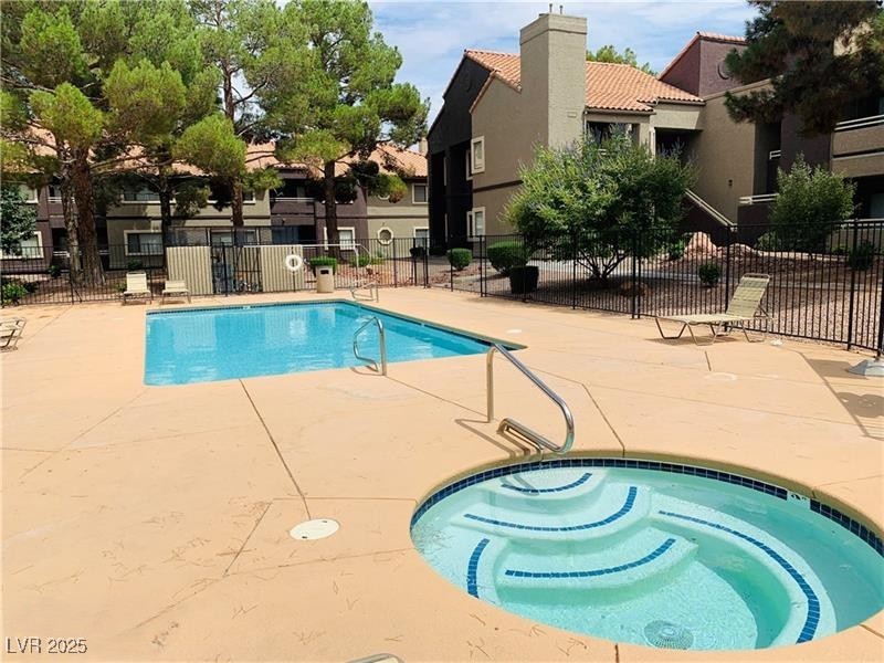 5026 South Rainbow Boulevard, Unit 203 Las Vegas, NV 89118 - Photo 27 of 31 Community pool with a patio and a community hot tub