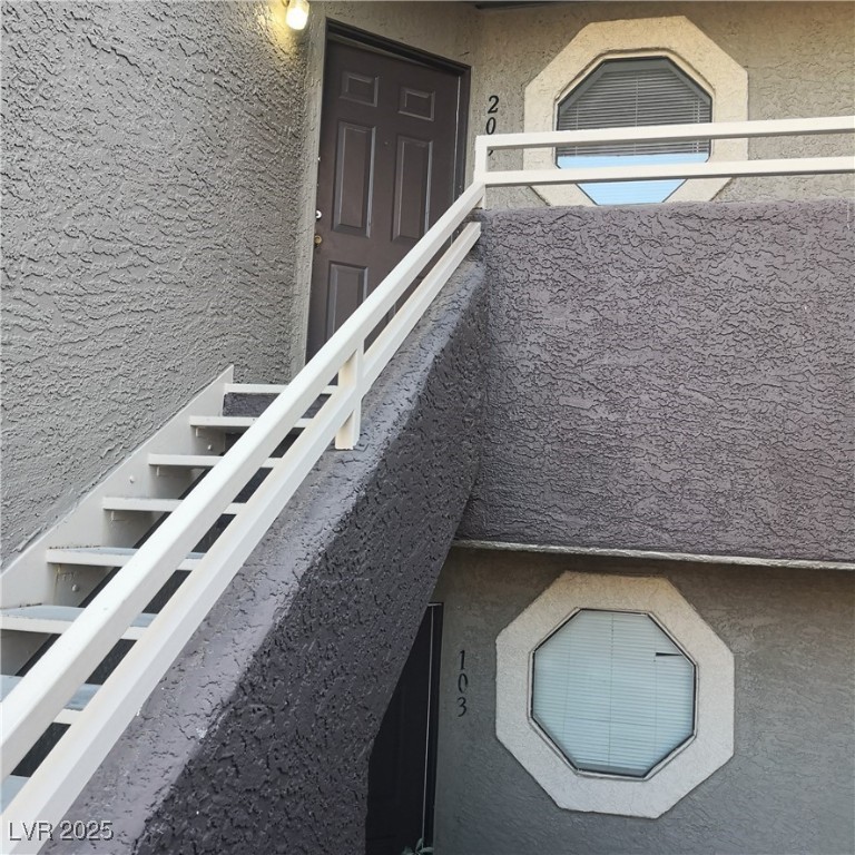 5026 South Rainbow Boulevard, Unit 203 Las Vegas, NV 89118 - Photo 3 of 31 View of front of house featuring stucco siding and a tiled roof