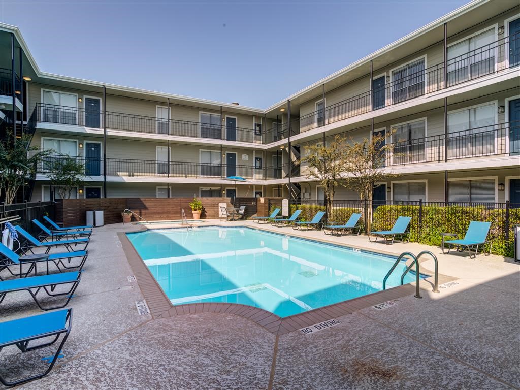 a view of a swimming pool with a lounge chair