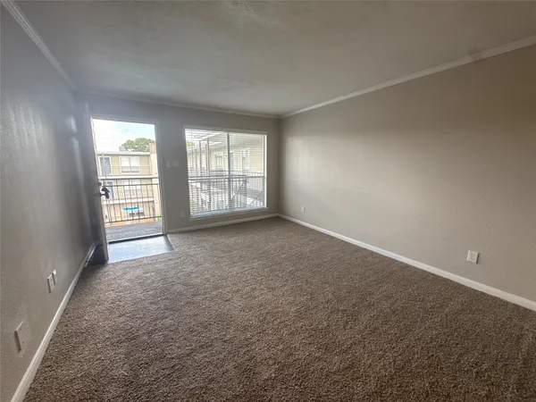 a view of an empty room and a ceiling fan