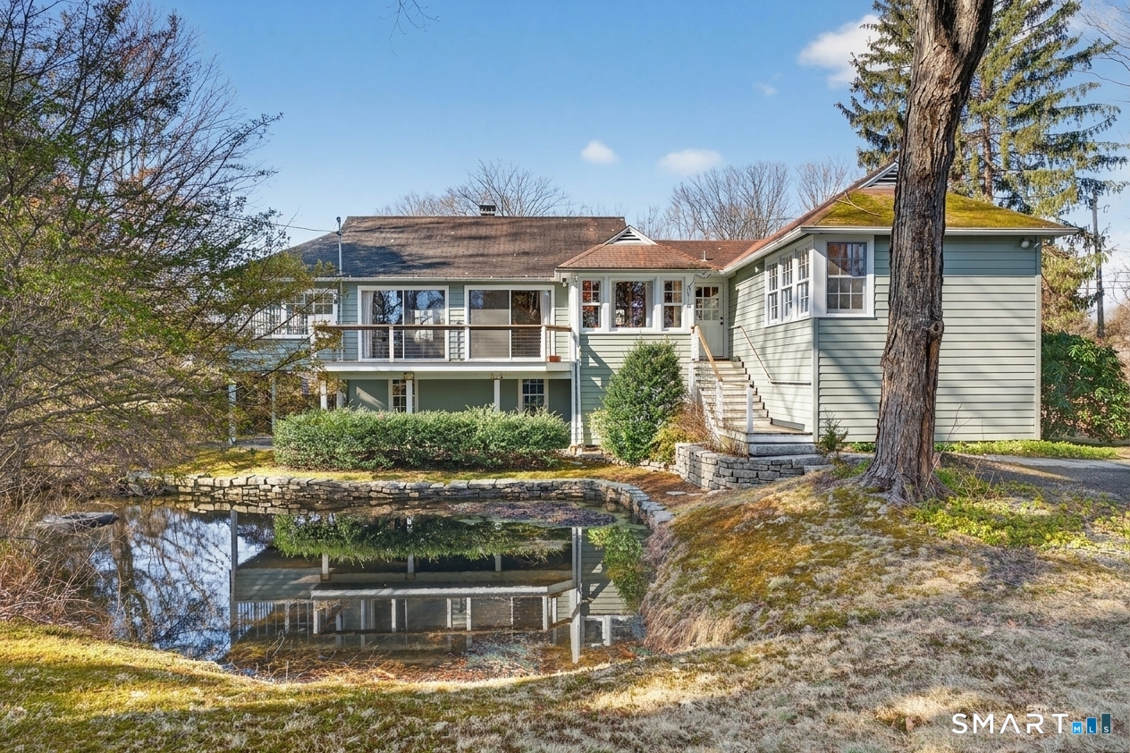 46 A Beach Avenue Madison, CT 06443 - Photo 1 of 32 a front view of a house with a yard