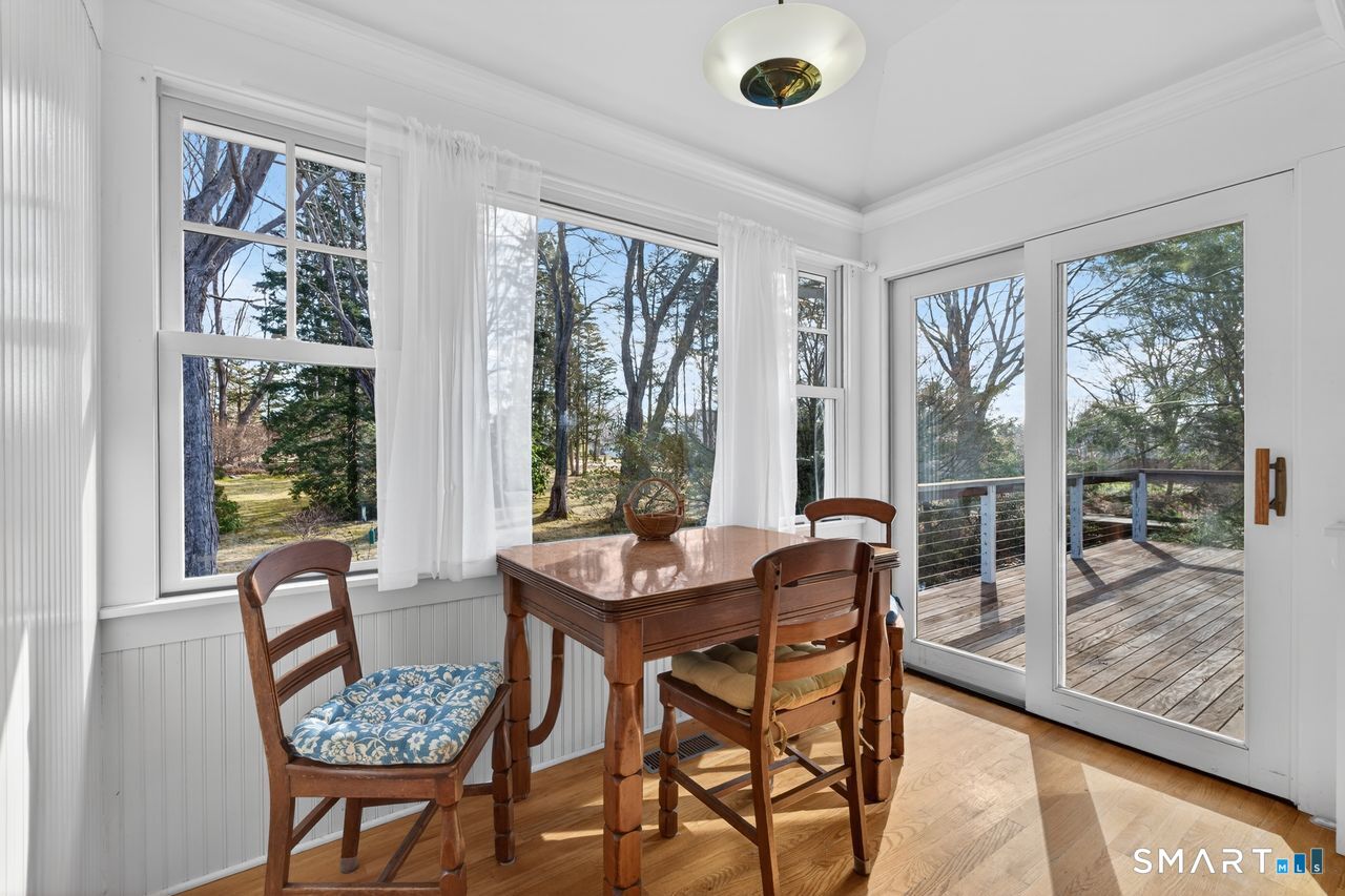 46 A Beach Avenue Madison, CT 06443 - Photo 12 of 32 a dining room with furniture and a floor to ceiling window
