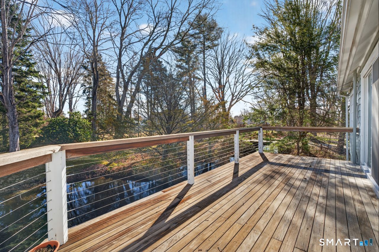 46 A Beach Avenue Madison, CT 06443 - Photo 14 of 32 a view of a balcony with wooden floor and trees