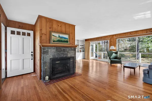 a living room with furniture a dining table and large windows