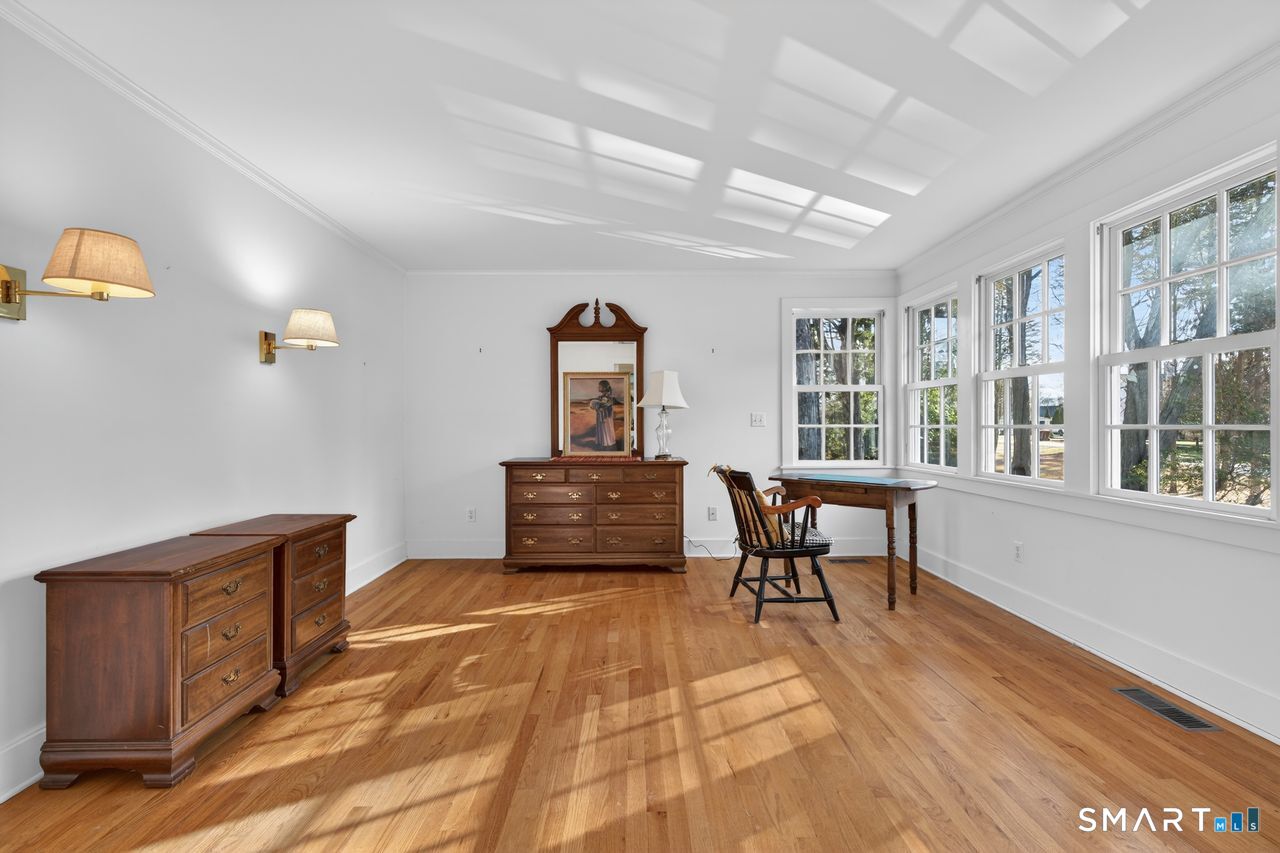 46 A Beach Avenue Madison, CT 06443 - Photo 23 of 32 a living room with furniture a dining table and large windows