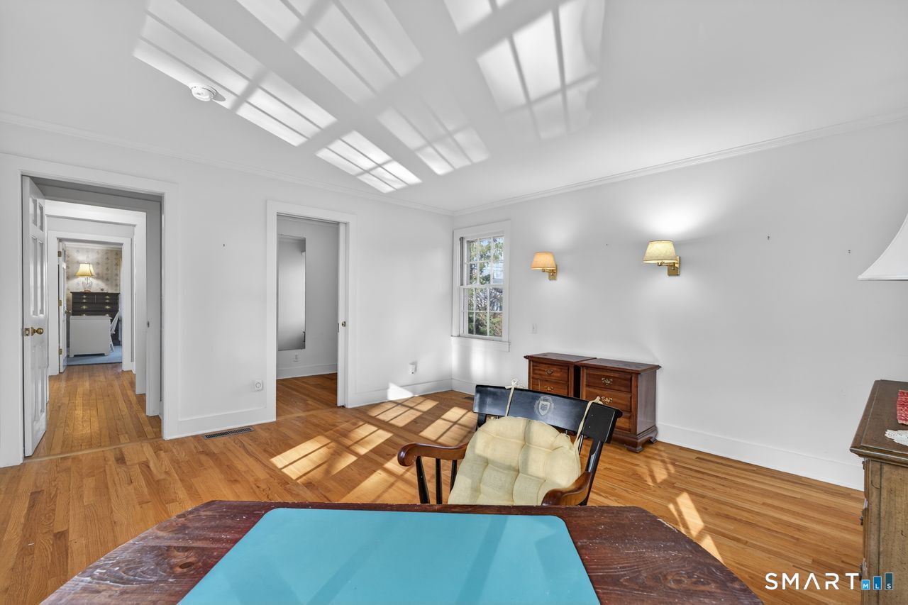 46 A Beach Avenue Madison, CT 06443 - Photo 24 of 32 a bedroom with a bed and wooden floor