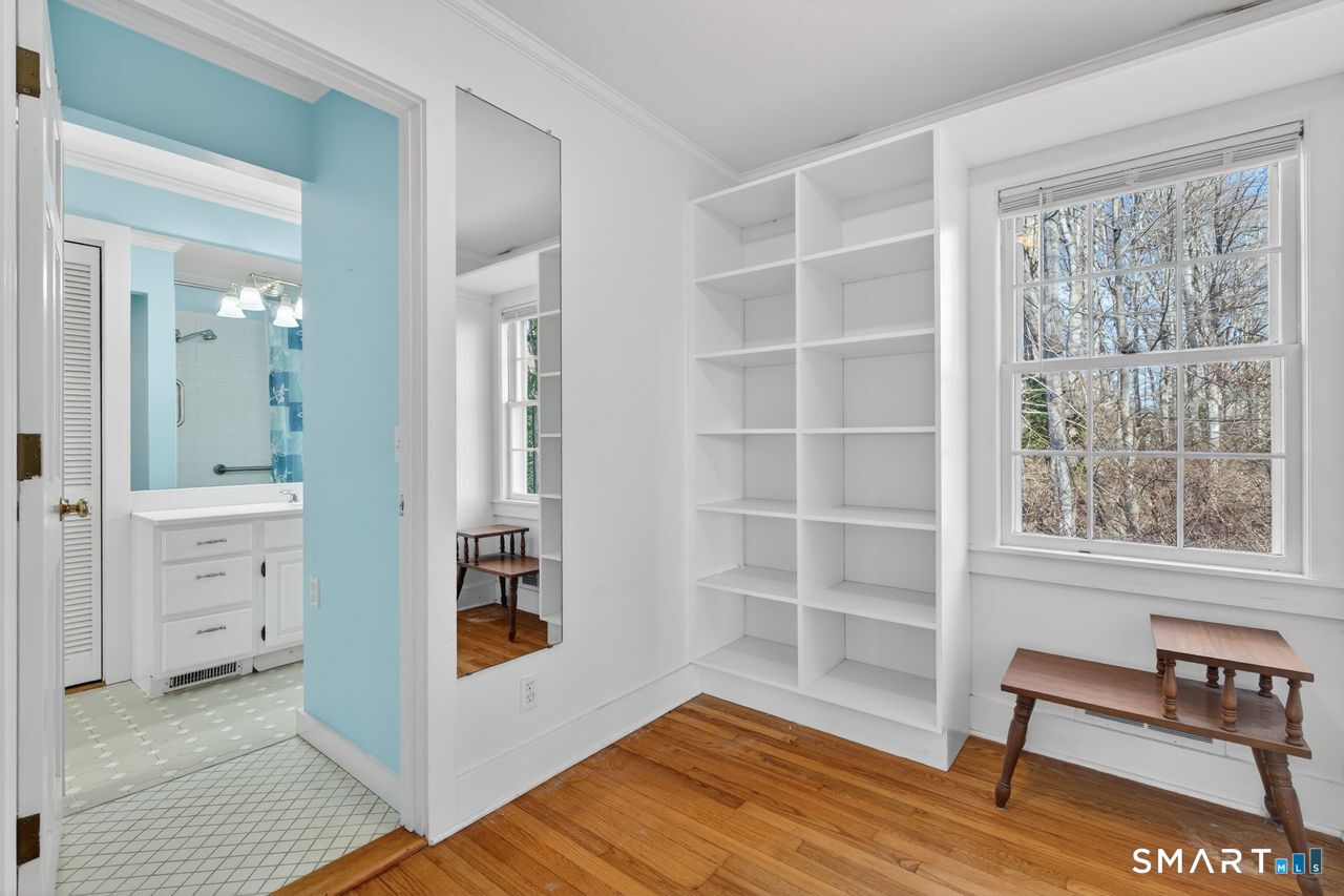 46 A Beach Avenue Madison, CT 06443 - Photo 25 of 32 a view of an empty room with a window and wooden floor
