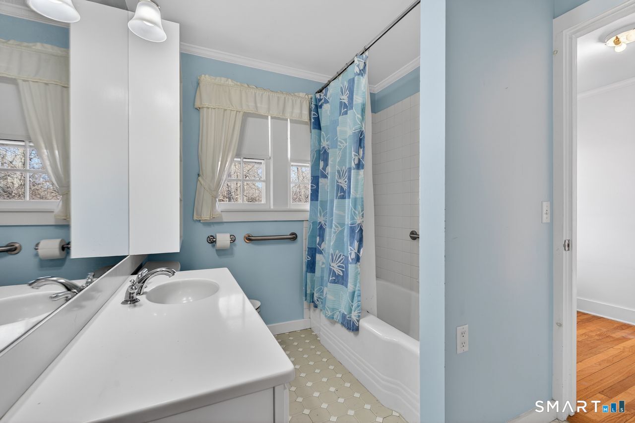 46 A Beach Avenue Madison, CT 06443 - Photo 27 of 32 a bathroom with a sink and a mirror