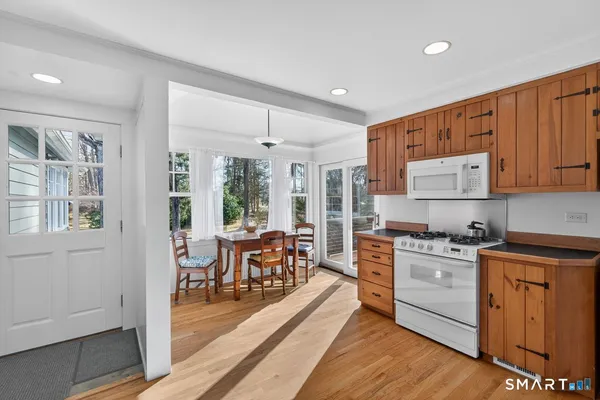 a dining room with furniture and a floor to ceiling window
