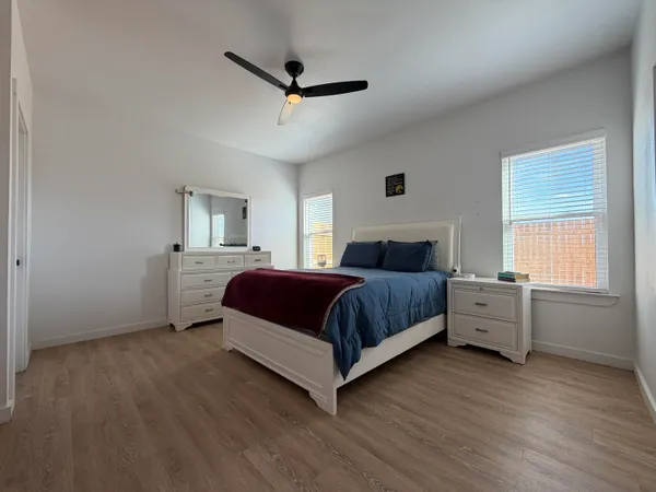 a spacious bedroom with a bed and a large window