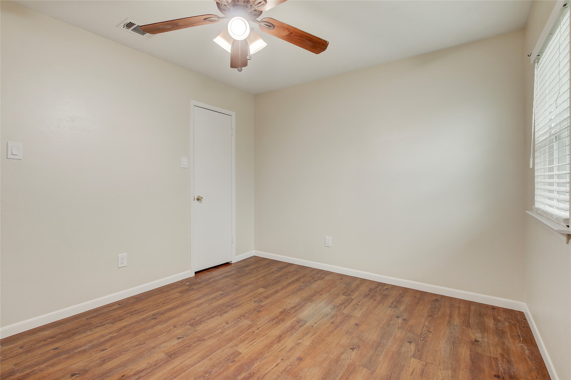 6902 Rifle Bend, Unit B Austin, TX 78736 - Photo 15 of 34 an empty room with wooden floor and windows