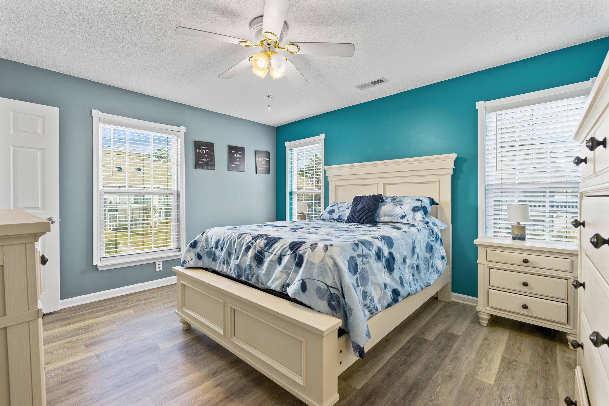 4353 Spa Drive, Unit 909 Little River, SC 29566 - Photo 18 of 39 Bedroom featuring light wood-style flooring, ceiling fan, and a textured ceiling