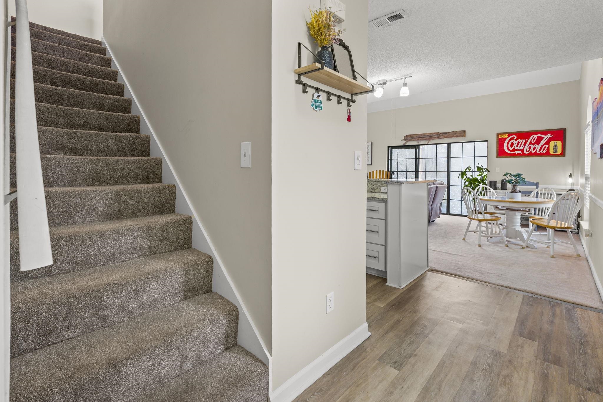 4353 Spa Drive, Unit 909 Little River, SC 29566 - Photo 26 of 39 Stairway with a textured ceiling and wood finished floors