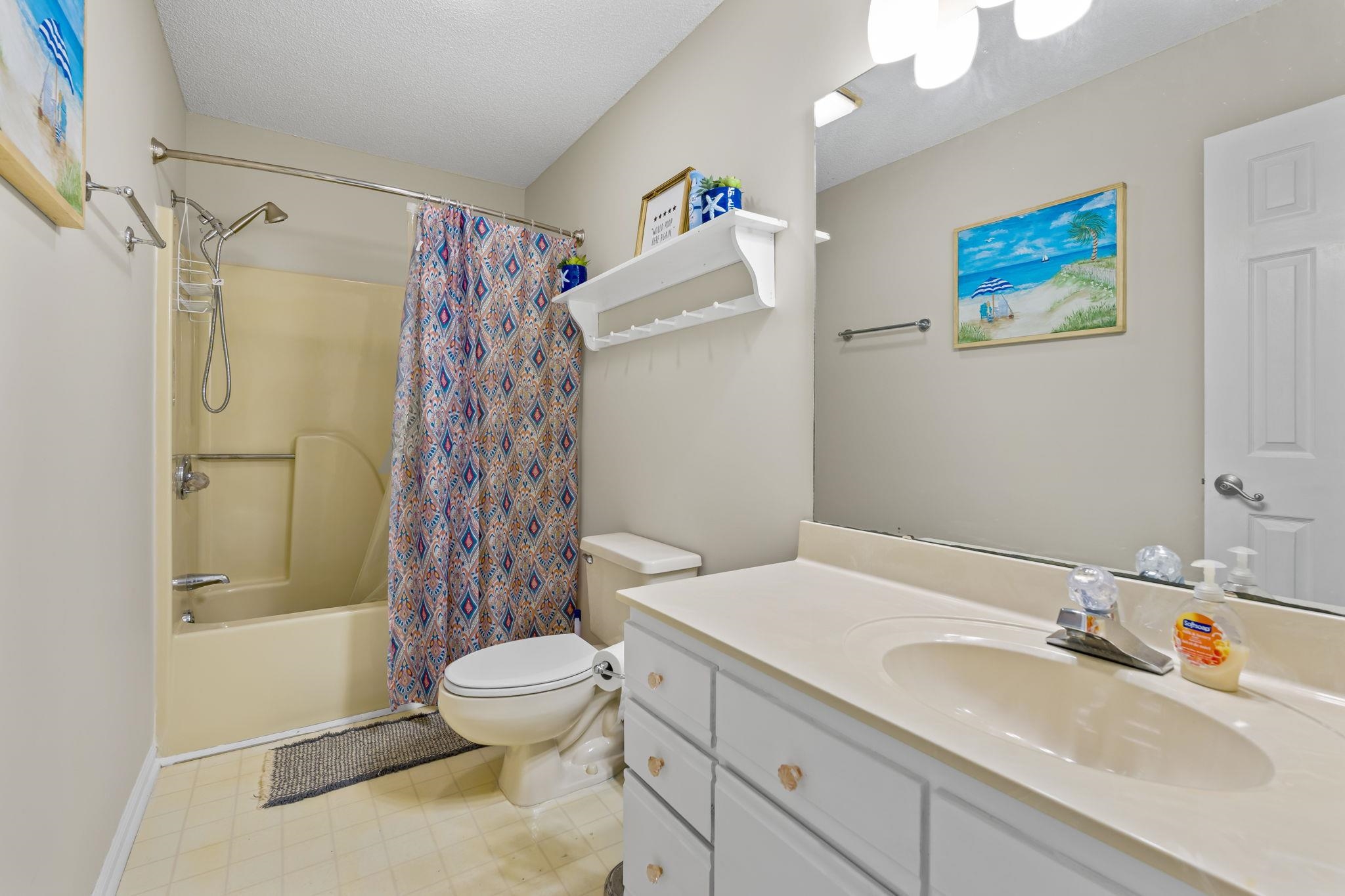 4353 Spa Drive, Unit 909 Little River, SC 29566 - Photo 31 of 39 Full bathroom with shower / bath combo with shower curtain, vanity, and light flooring