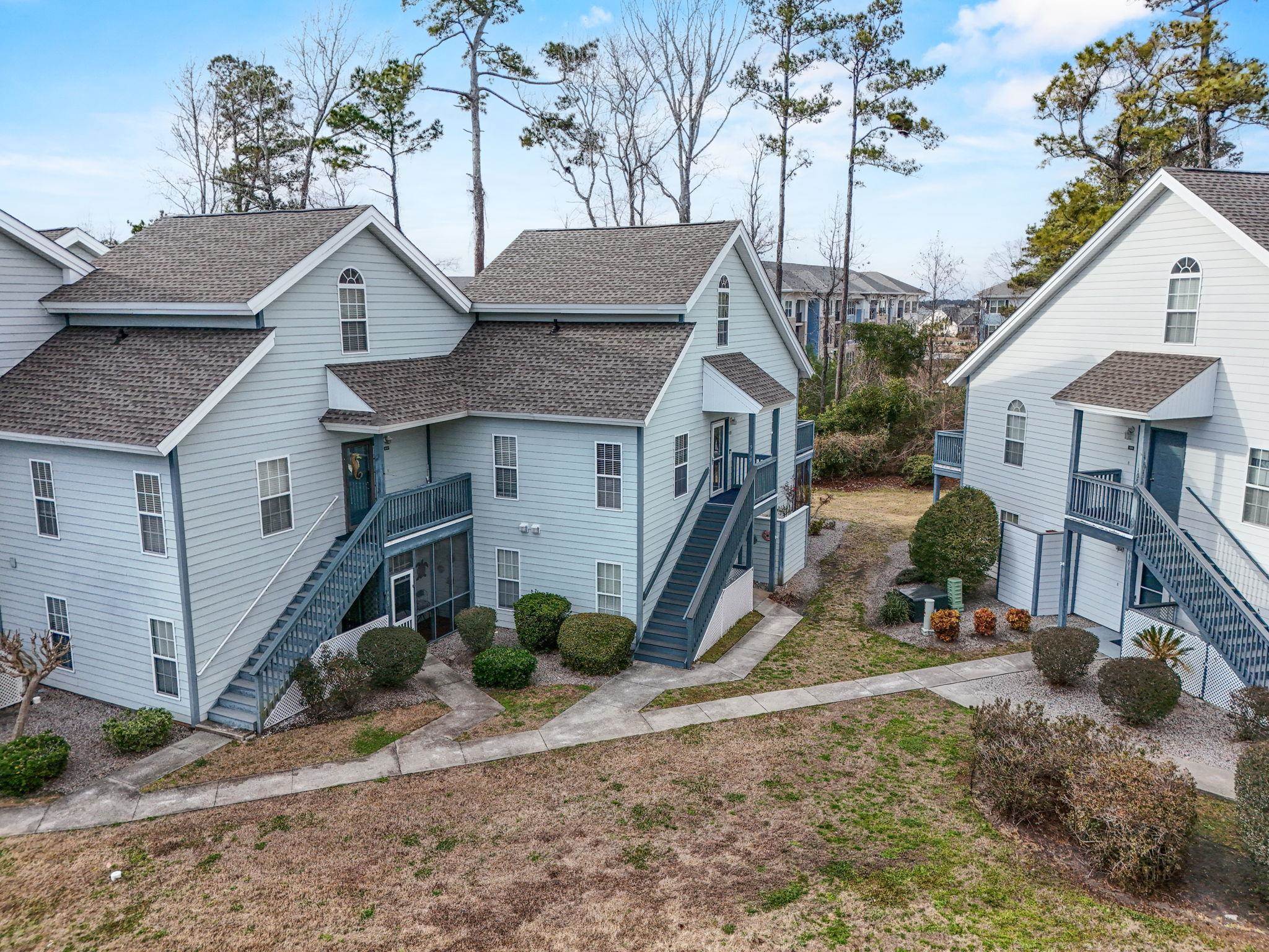 4353 Spa Drive, Unit 909 Little River, SC 29566 - Photo 32 of 39 Back of house featuring roof with shingles and stairway